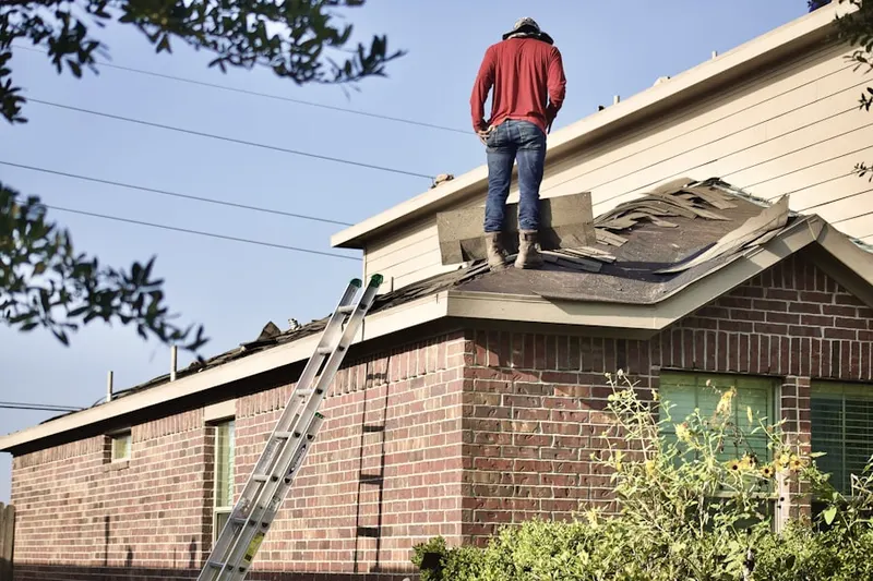 Professional roofer working on a residential roof in The Woods at Colony Crossing